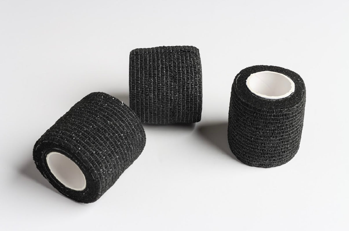 Three rolls of black self-adhesive grip wrap band positioned side by side on a white background.