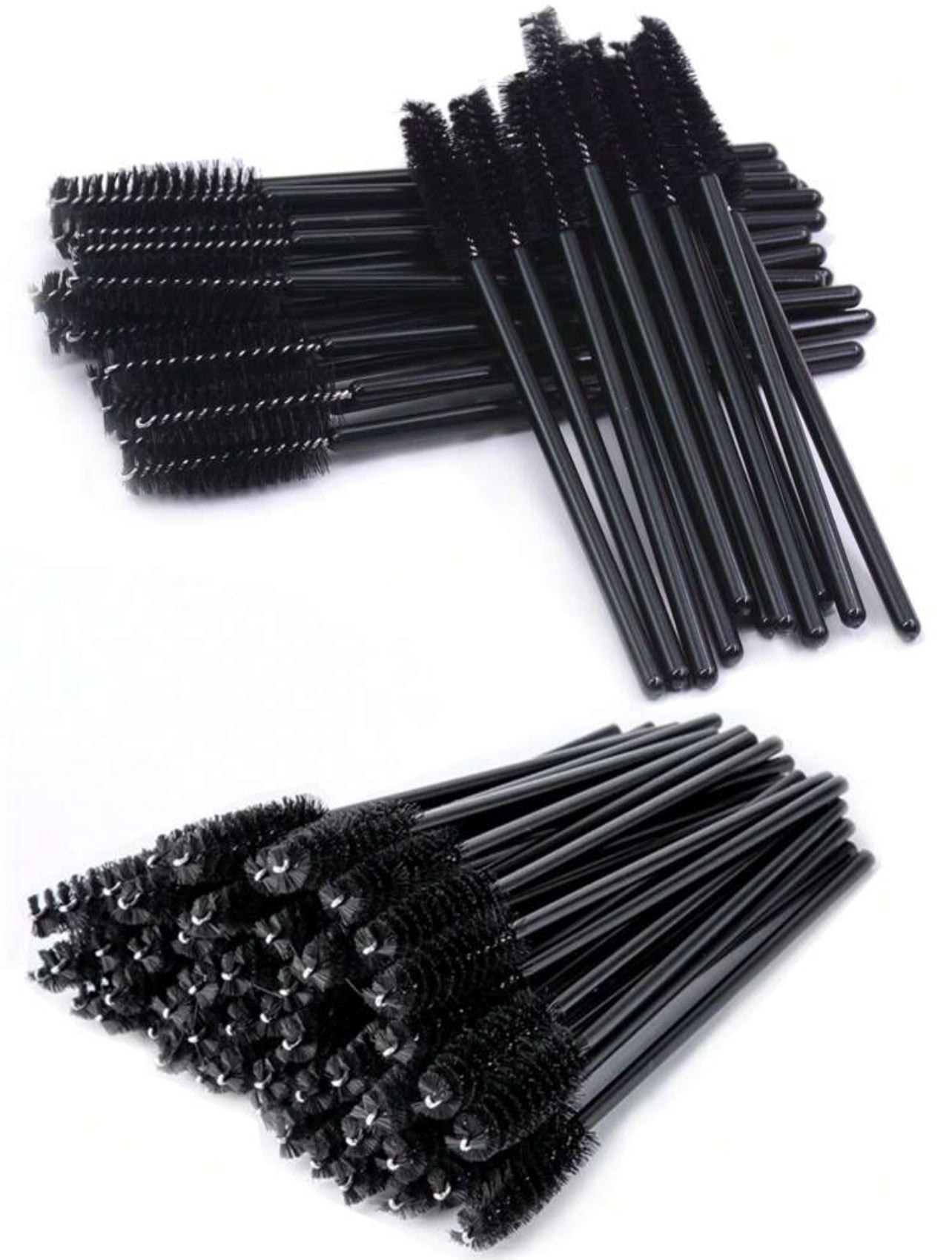 Two piles of disposable black eyelash brushes with dense nylon bristles, one pile facing up and the other pile facing down.