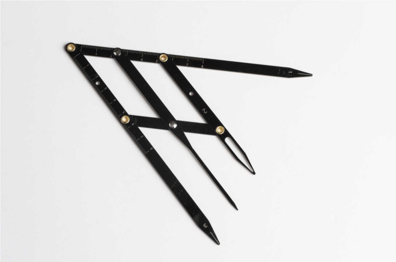 A set of stainless steel measuring tools with black handles and silver measurement markings laid out on a white background. Universal measuring tool - Eyebrow Measuring tool