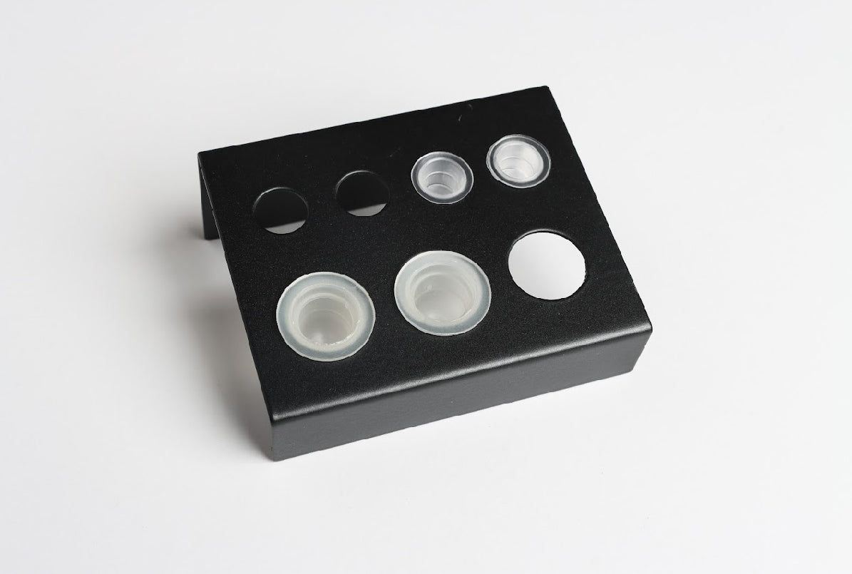 A black ink cup holder with multiple cups placed in it. Ink Cup Holder - Pigment Holder